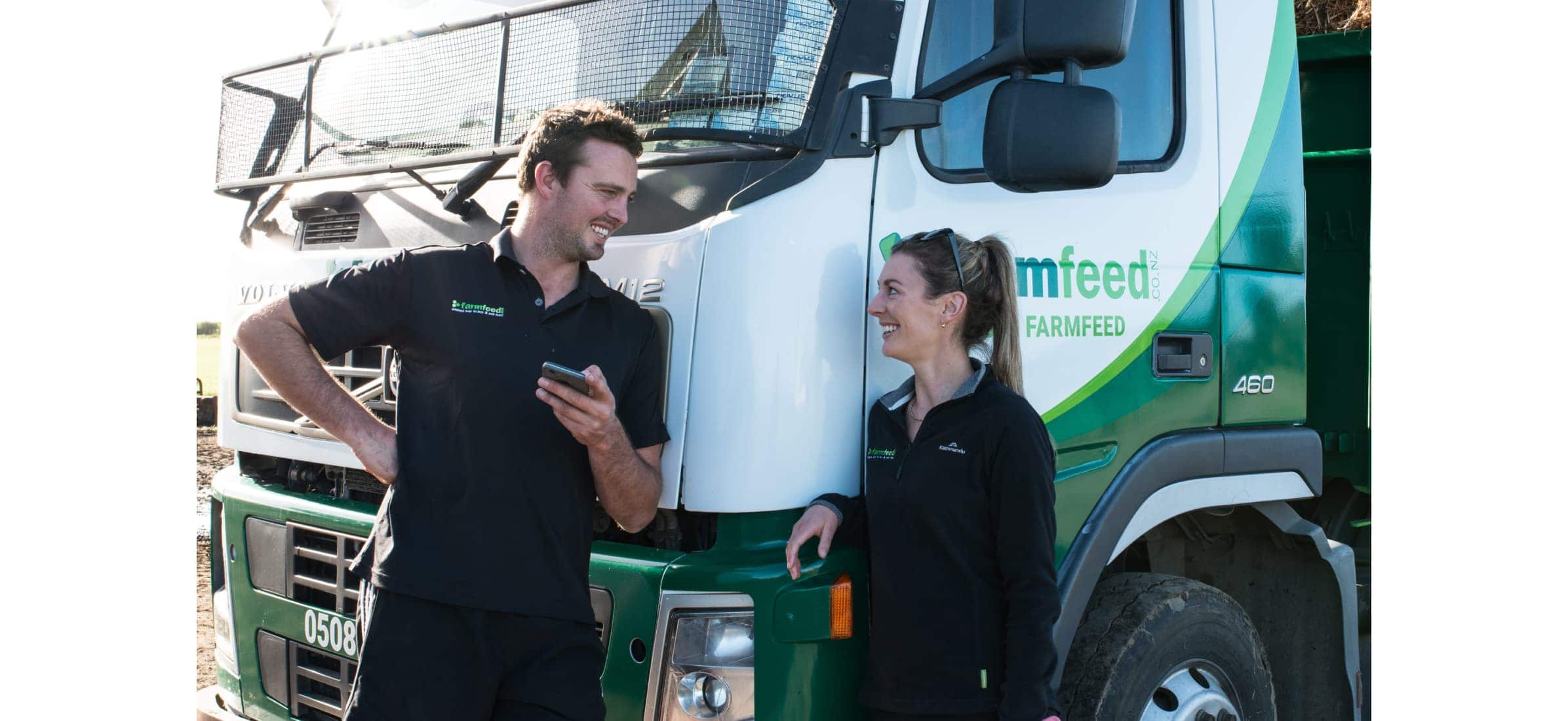 Simon Washer and partner Monica chatting in front of a Farmfeed truck.